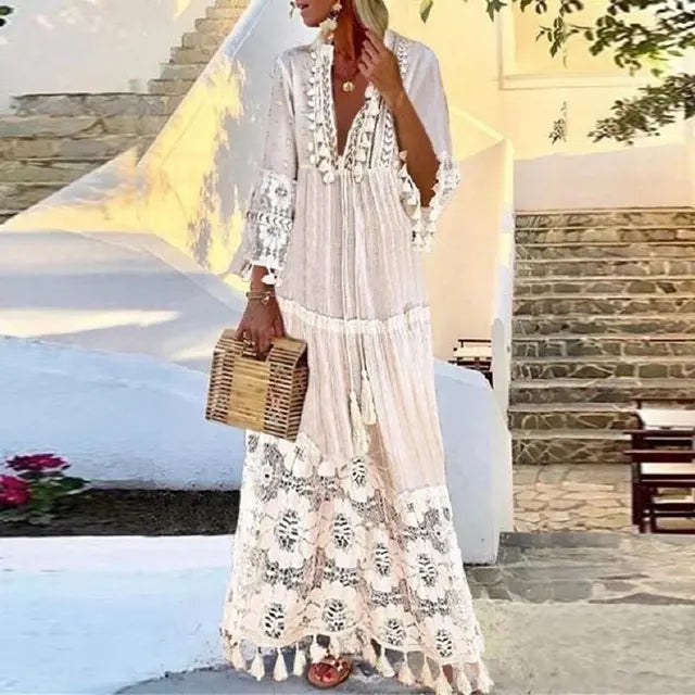 Flowy women's boho maxi dress with lace and tassel accents, ideal for elegant casual wear or beach outings.