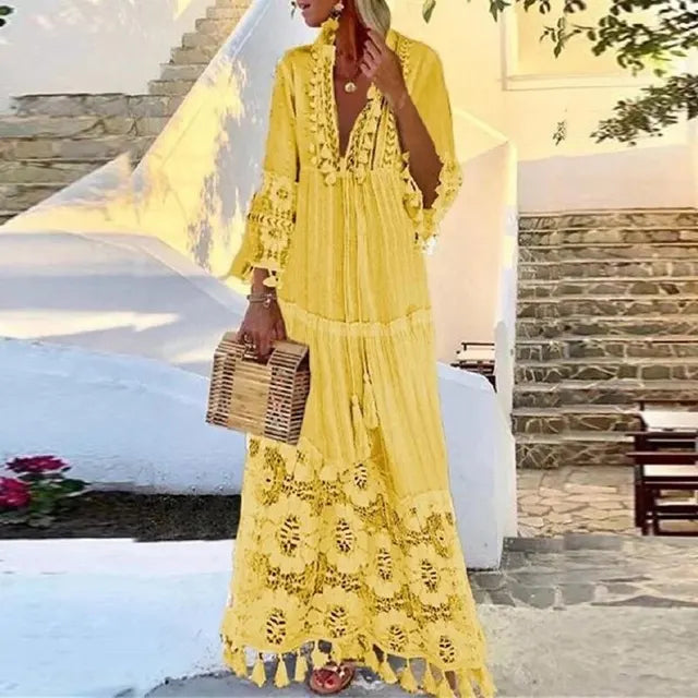 Long women's boho dress, elegant with delicate lace and stylish tassel accents, offering a free-spirit summer look.