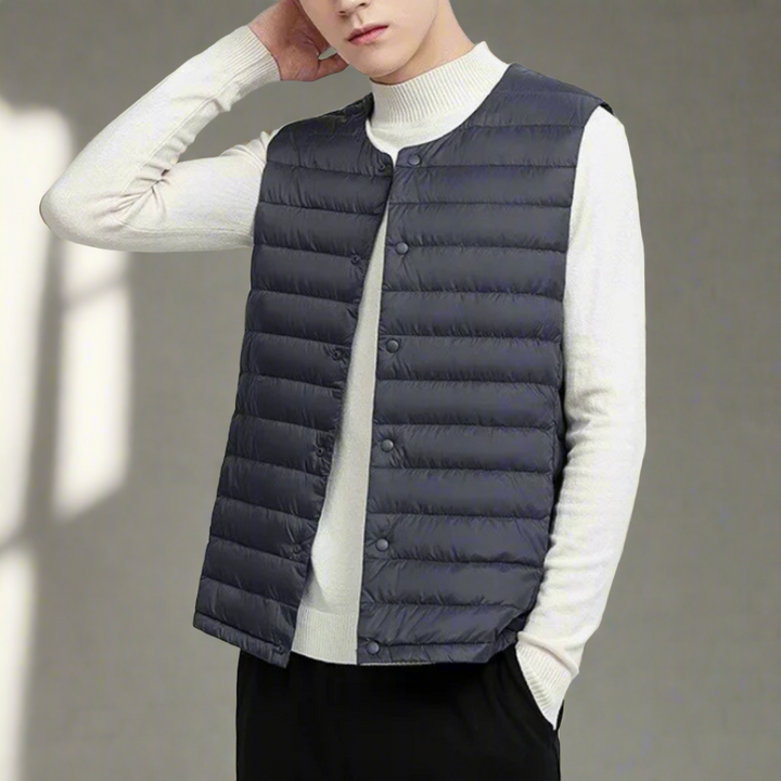 Men's quilted lightweight bodywarmer with a minimal snap front closure, perfect for layering outerwear.