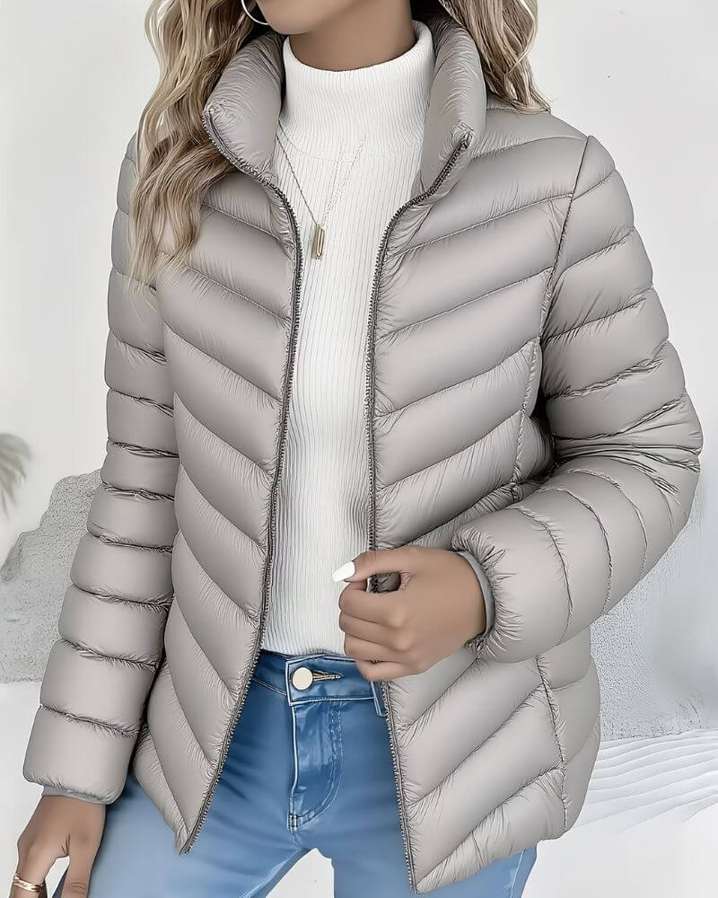 Stylish women's cropped puffer jacket. Lightweight, warm, and featuring a stand collar. Great autumn outerwear.