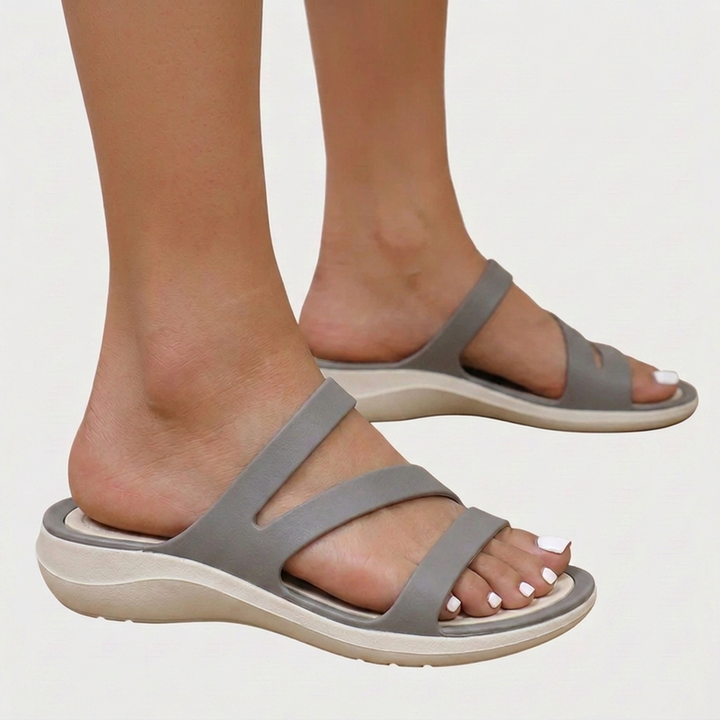 Casual women's open-toe sandals featuring multi-straps & orthopaedic comfort. Perfect flat footwear for summer ease.