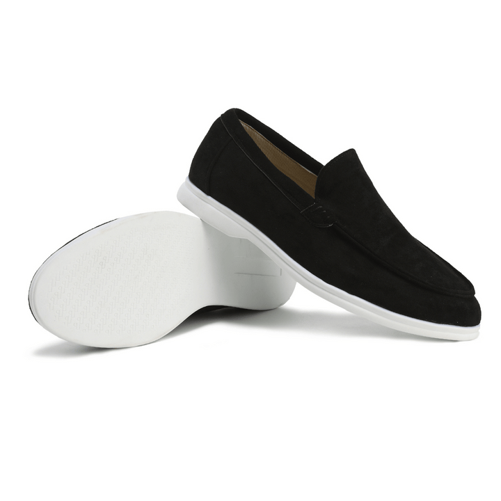 Minimalist black leather slip-on loafers for men, combining fashion, comfort, & versatility.