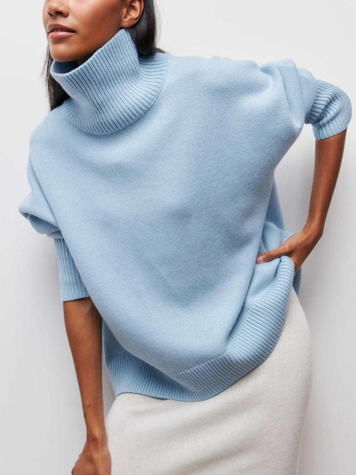 Stylish women's oversized turtleneck sweater with trendy elbow slit, cozy knit, versatile fall fashion.
