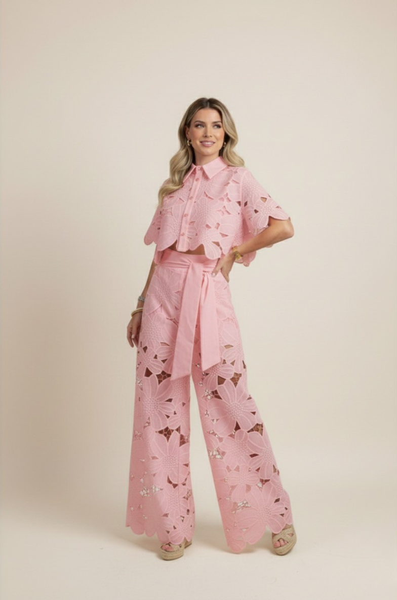 Flat lay of a vibrant floral embroidered two-piece set featuring a top and wide-leg pants. Holiday wear.
