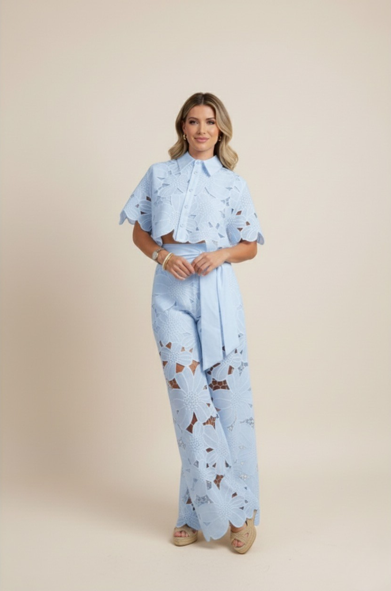 Back view of a woman wearing a comfortable floral embroidered wide-leg two-piece set, summer-ready.