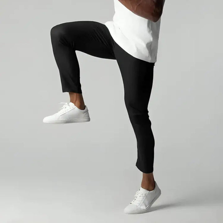 Close-up of men's tapered ankle length chinos. Flat front smart casual pants suitable for work or leisure.