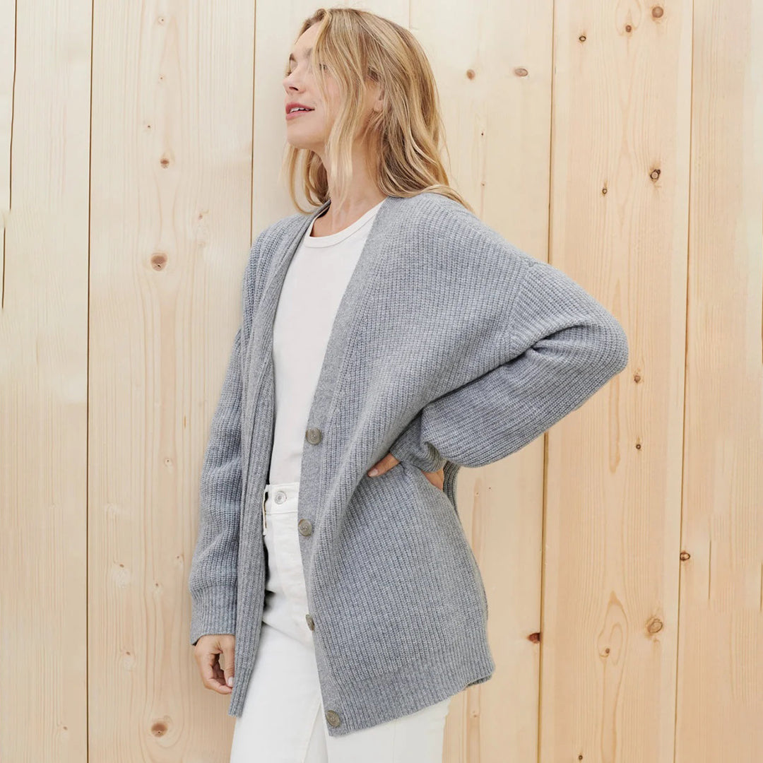 Warm women's long rib-knit cardigan, oversized and cozy, perfect for winter layering style.