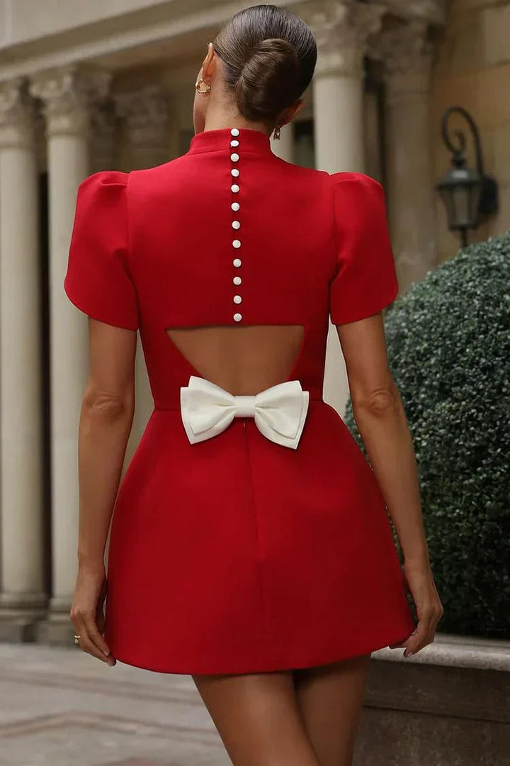Elegant women's sleeveless mini dress with a distinct back bow, offering a chic & versatile look.