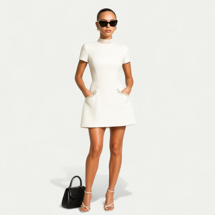 Fashionable women's elegant mini dress with stylish pearl trim and comfortable short sleeves, day to evening.