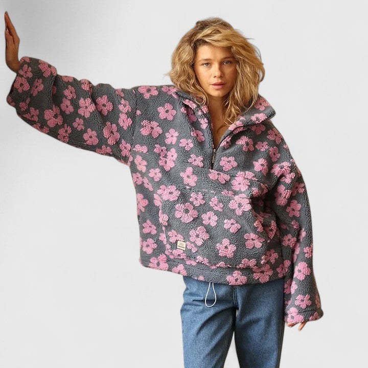 Comfortable loose-fit women's floral jumper, featuring a stylish half-zip and colorful pattern for spring.