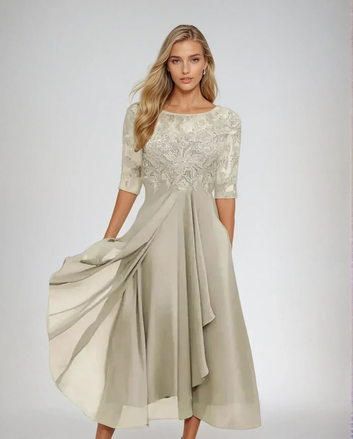 Women's formal lace midi dress with elegant three-quarter sleeves, suitable for special occasions.