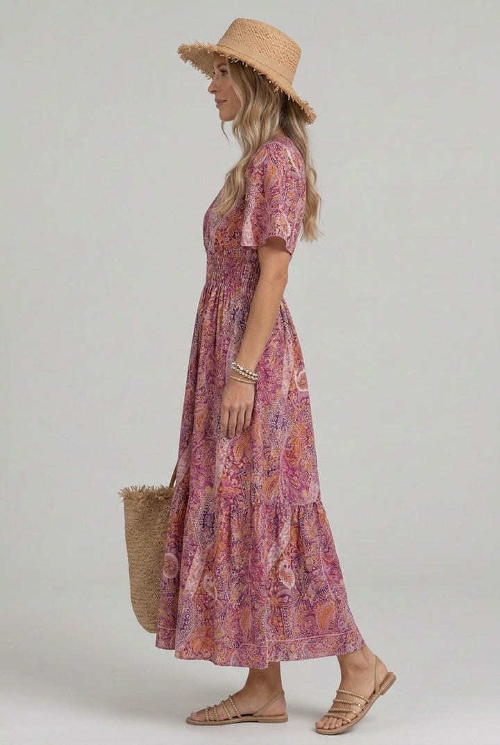Elegant women's maxi dress with a vibrant paisley print, V-neck, and comfortable smocked waist, ideal for casual wear.