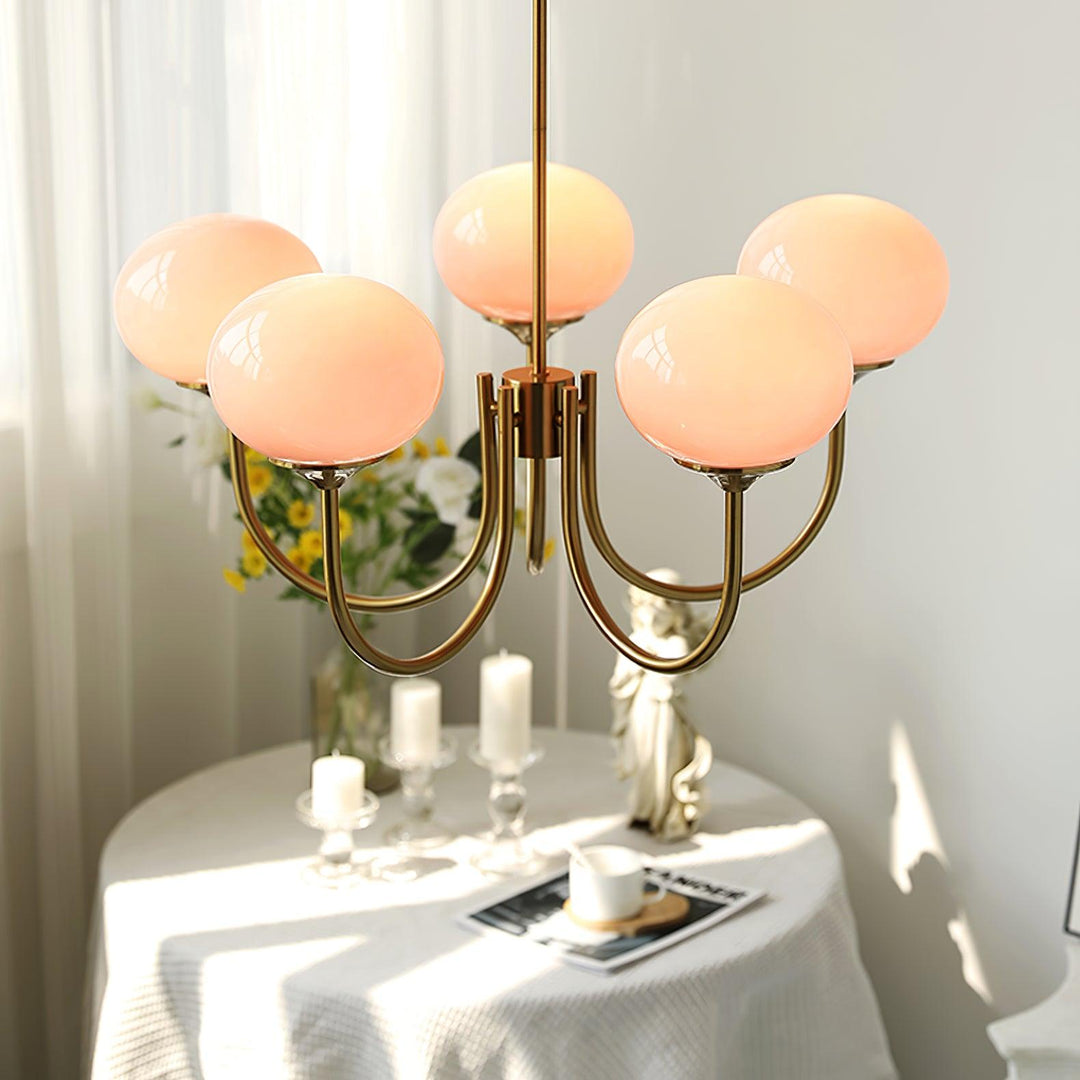 Minimalist chrome circle ceiling light, provides ambient glow for kitchen islands.
