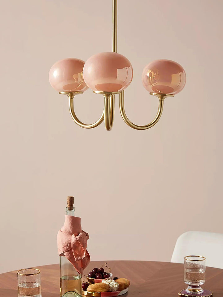 Brass sphere pendant with diffused light, modern ceiling lamp for vibrant living.