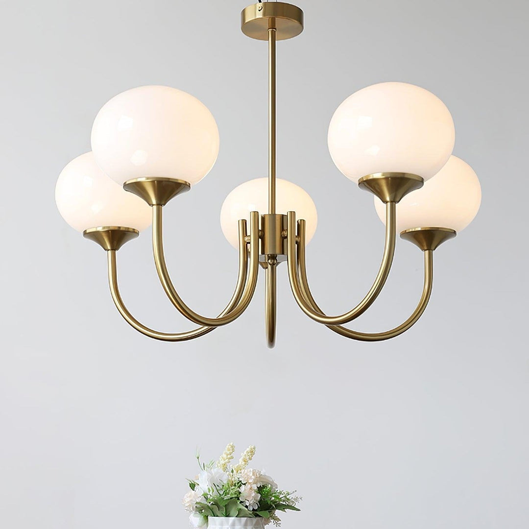 Modern brass diffused light pendant, chic fixture for elegant bedroom decor.