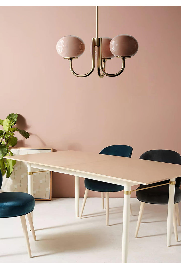 Modern brass pendant fixture, elegant glass sphere for a chic kitchen space.