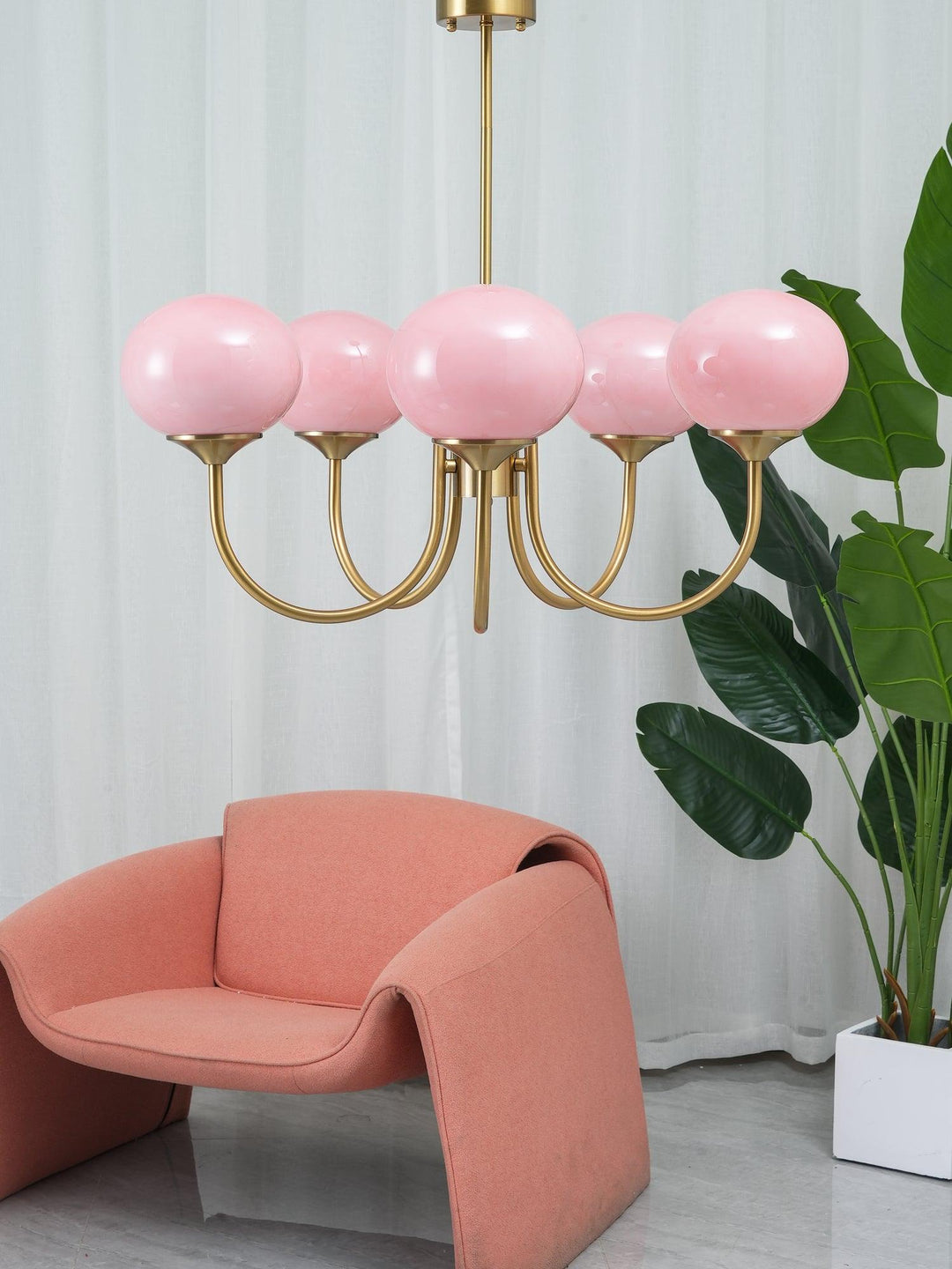 Chic brass pendant light, elegant sphere fixture for contemporary kitchen islands.