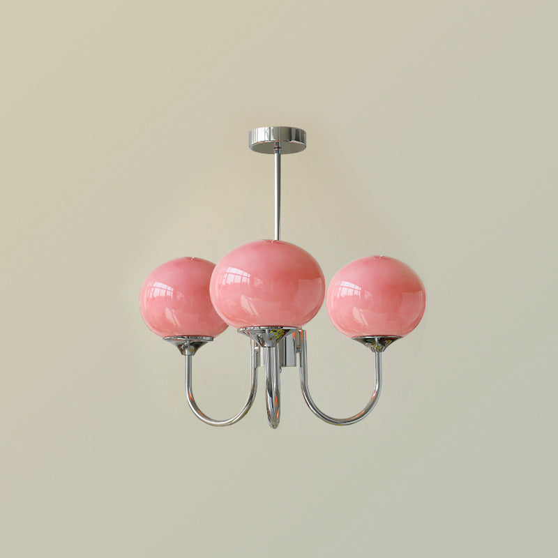 Modern chrome diffused globe lamp, provides soft light for a cozy living area.
