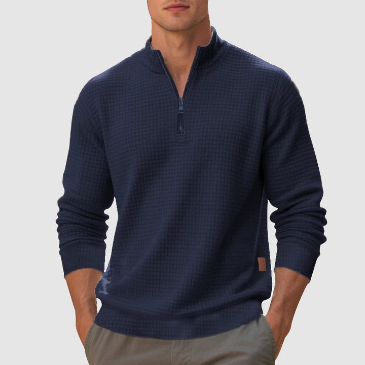 Close-up of men's quarter-zip jumper with stand collar and textured knit, showcasing quality & style.