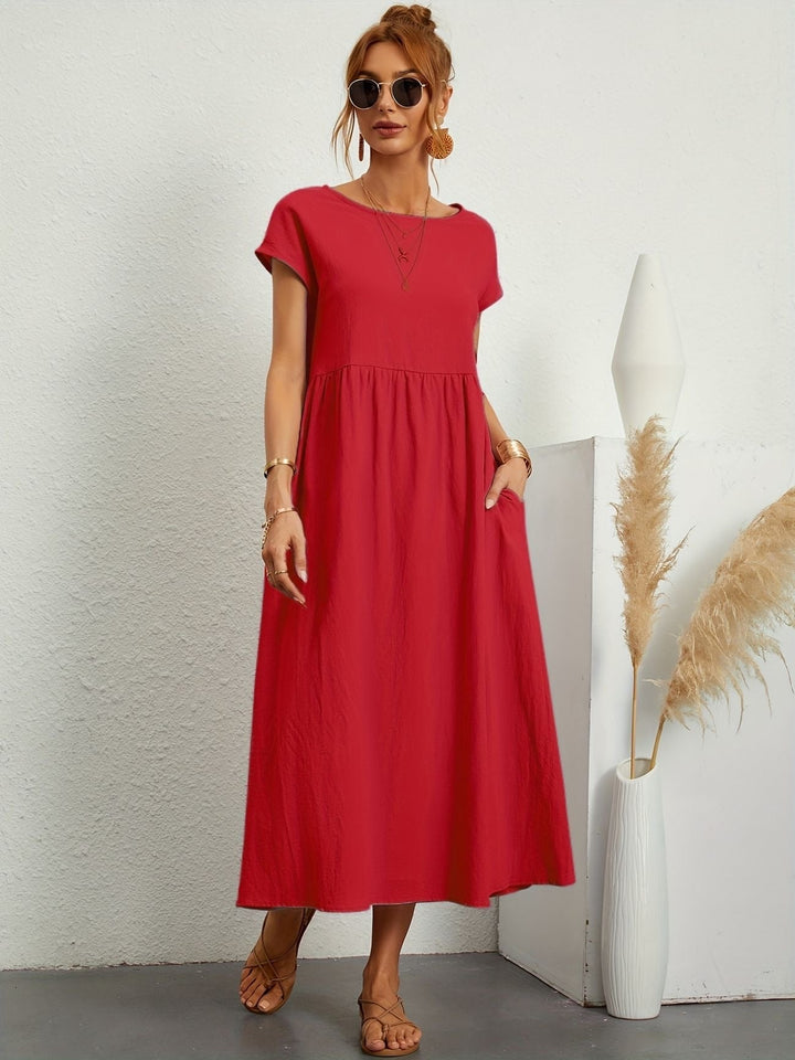 Flowy summer women's loose maxi dress, perfect for warm weather. Features a round neck, short sleeves, and pockets.