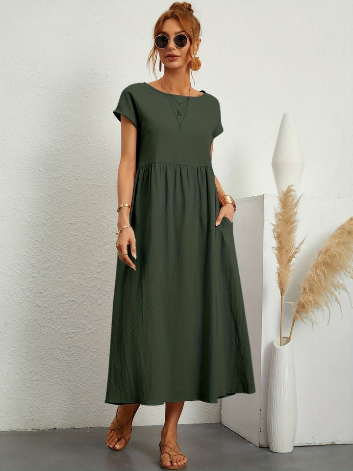 Women's loose fit maxi dress with short sleeves, round neck, and practical pockets. Perfect for summer comfort.
