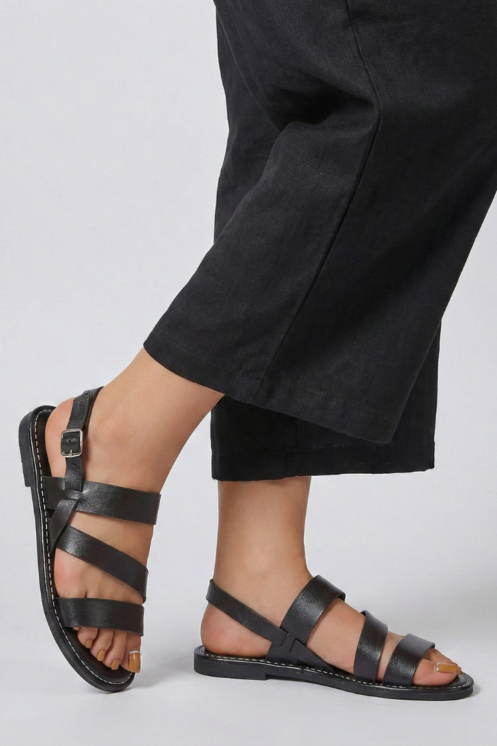 Stylish women's flat sandals with back strap, great for fashion-forward ladies & warm-weather outfits.