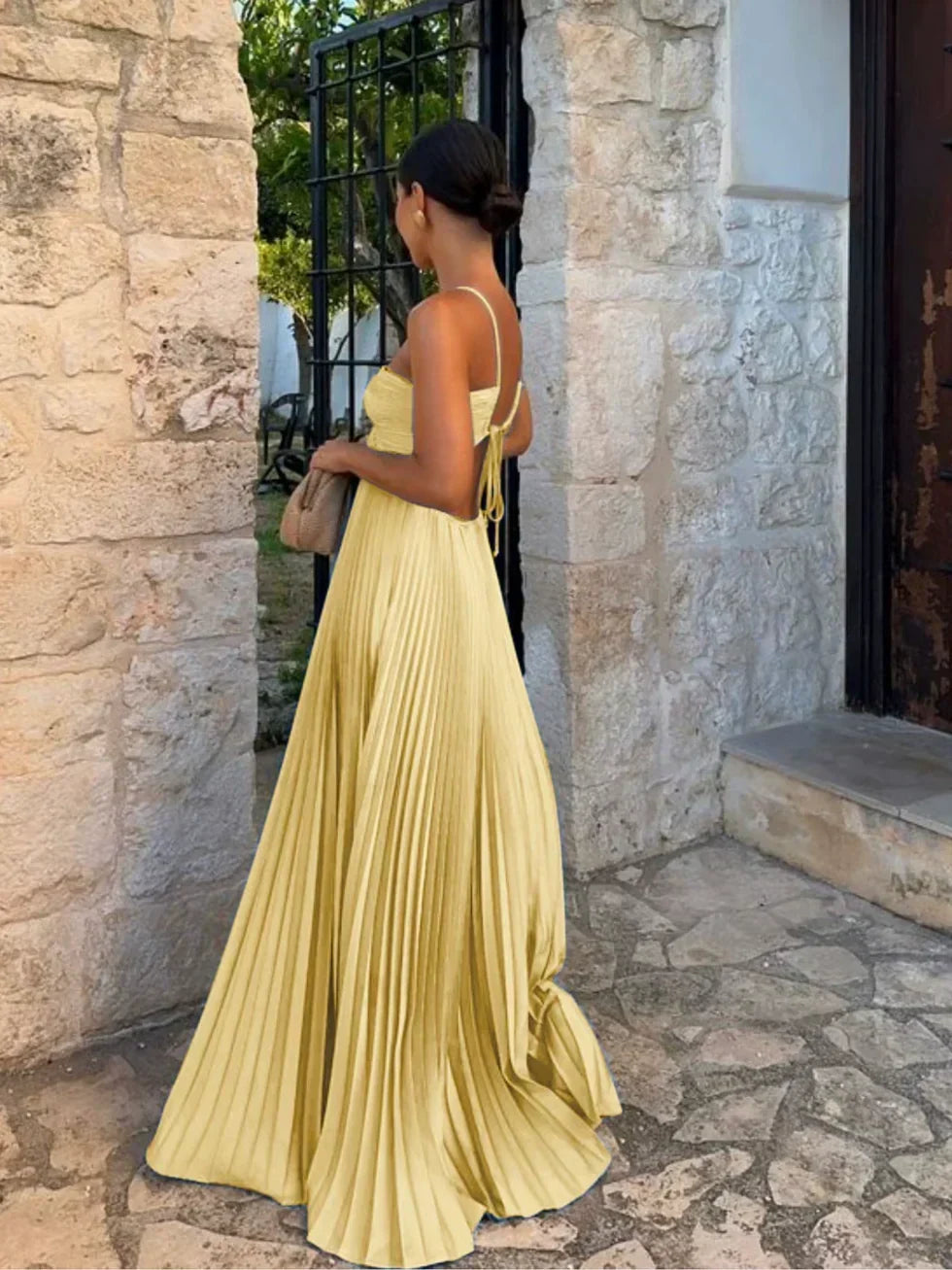 Close-up of a women's pleated maxi dress, showcasing the stylish halter neck and elegant fabric pleats.