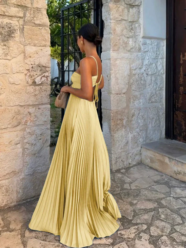 Close-up of a women's pleated maxi dress, showcasing the stylish halter neck and elegant fabric pleats.