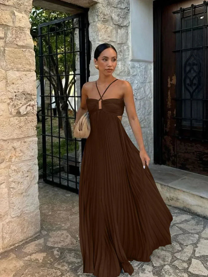 Detailed view of the high-waisted side cut-out on a women's pleated halter neck maxi dress, stylish and chic.