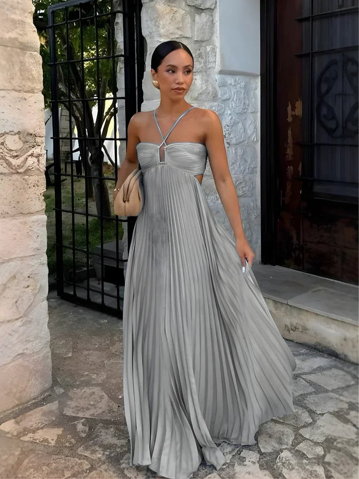 Stunning women's pleated halter neck maxi dress with side cut-outs, an elegant choice for summer occasions.