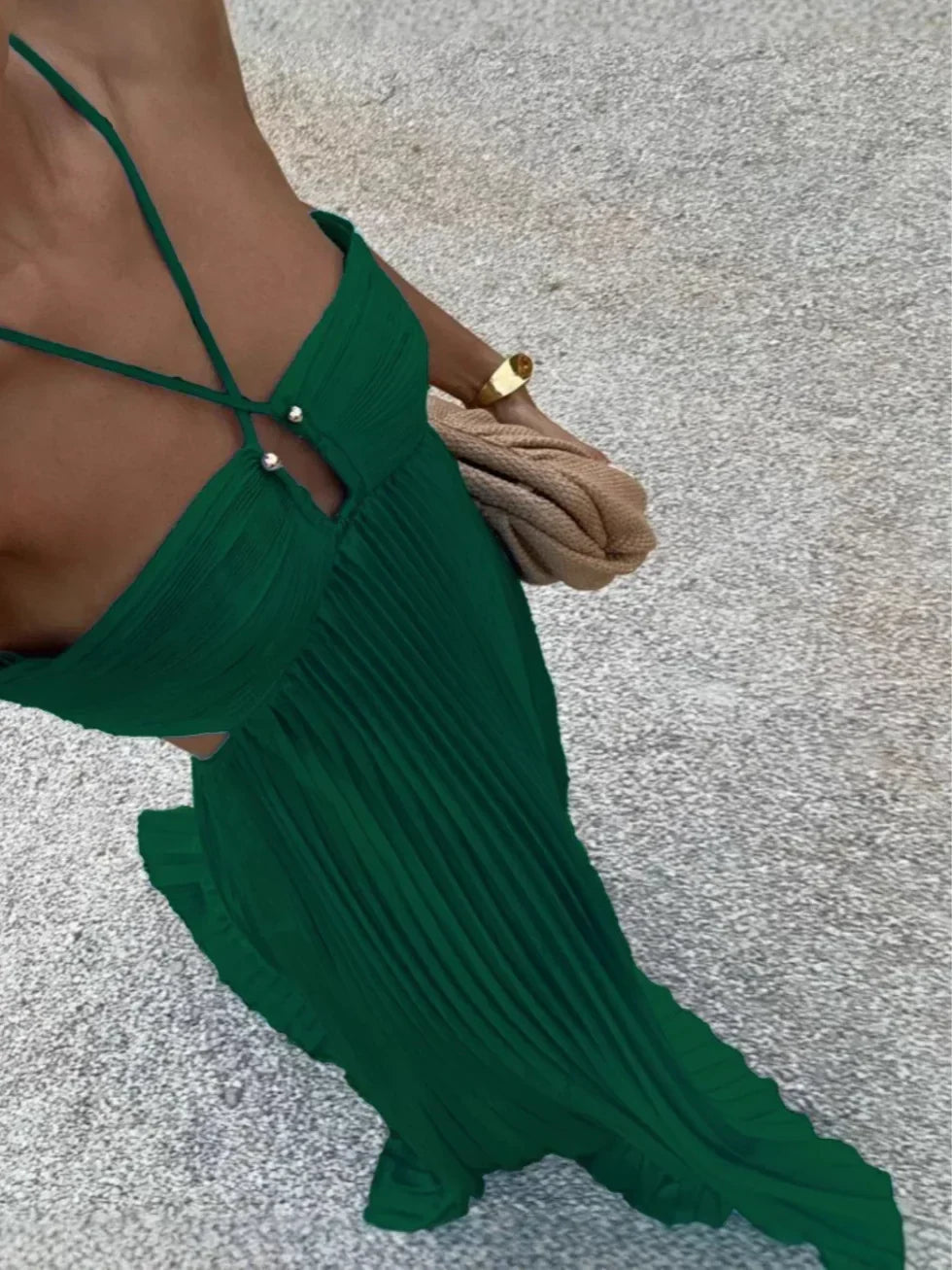 Texture shot of a women's pleated maxi dress fabric, highlighting the graceful pleats and luxurious feel.