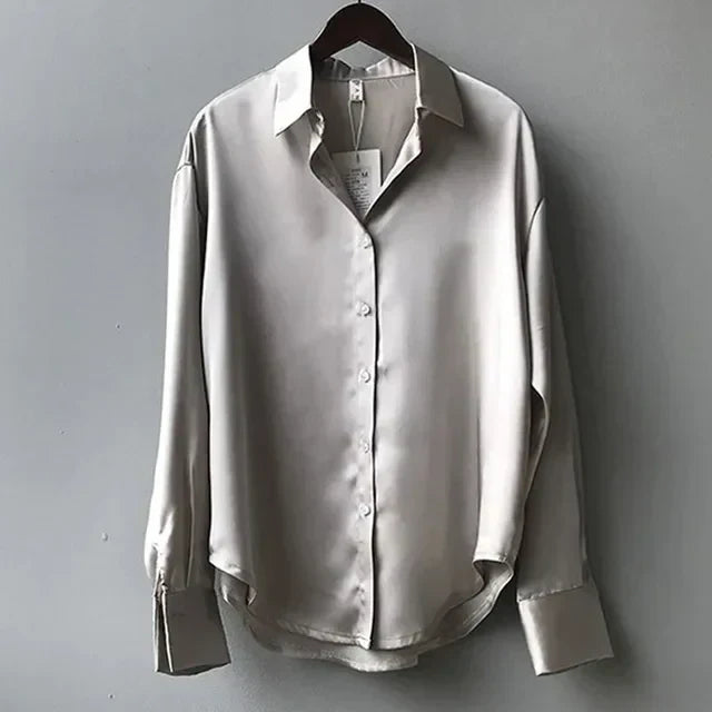 Elegant women's button-down shirt, a long-sleeve fashion top for a modern look. Perfect for office or casual styling.