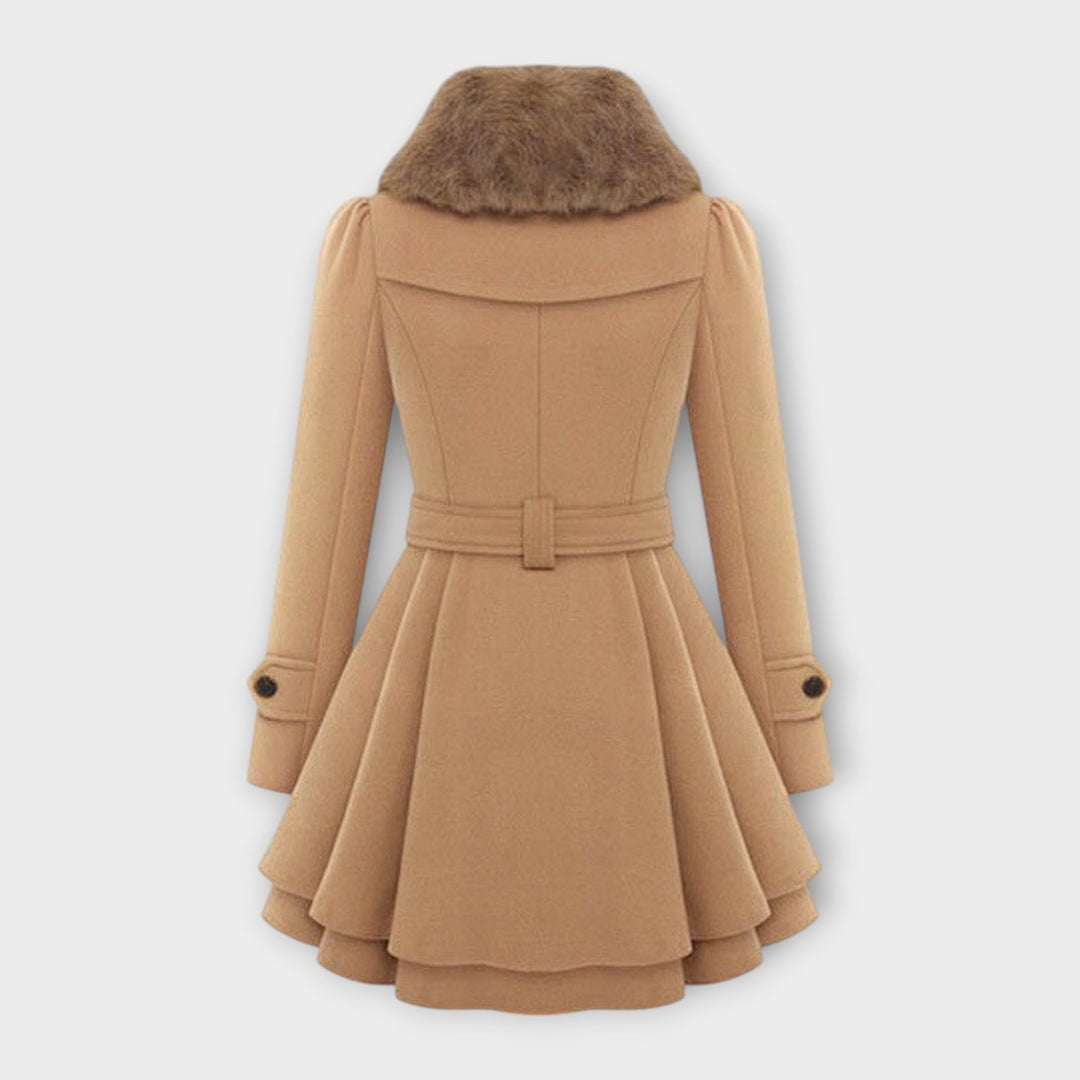 Chic women's elegant fall fashion dress coat. Double-breasted long winter jacket with luxurious faux fur collar.