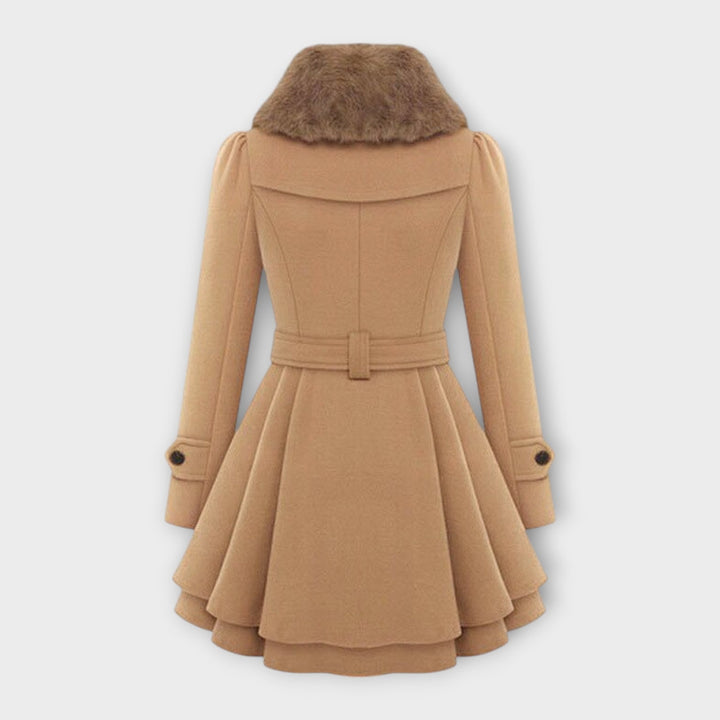 Chic women's elegant fall fashion dress coat. Double-breasted long winter jacket with luxurious faux fur collar.