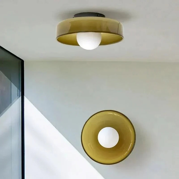 Nordic design glass ceiling lamp illuminating a stylish modern living room interior.