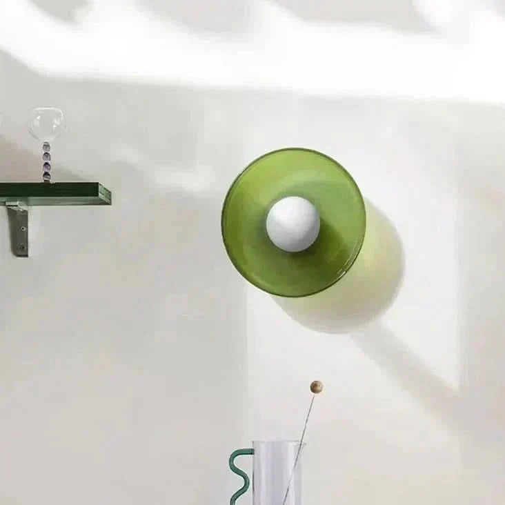 Minimalist glass ceiling lamp in a Scandinavian bedroom, creating warm ambient lighting.