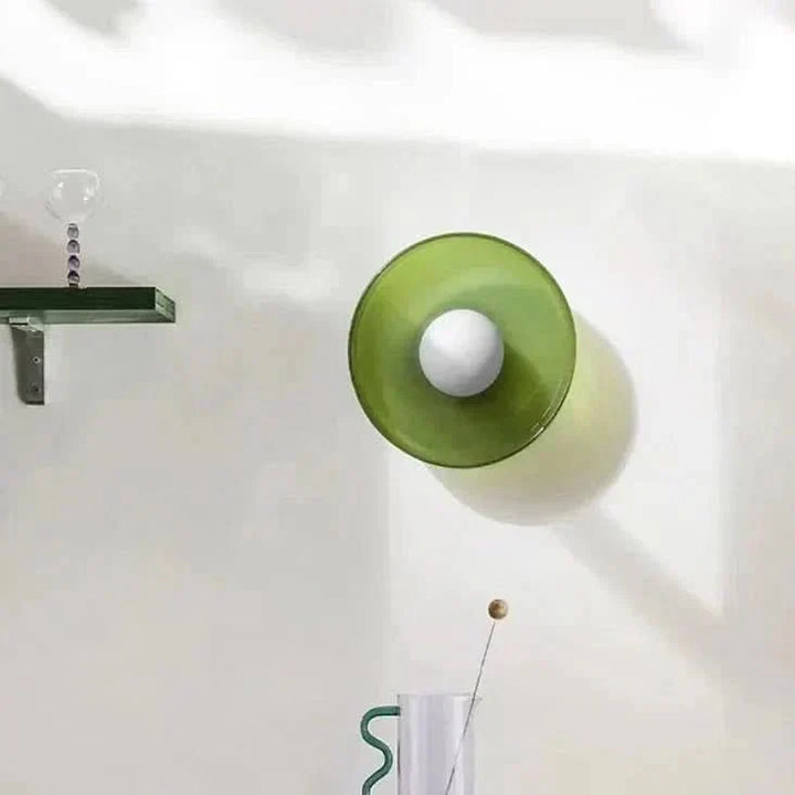 Minimalist glass ceiling lamp in a Scandinavian bedroom, creating warm ambient lighting.