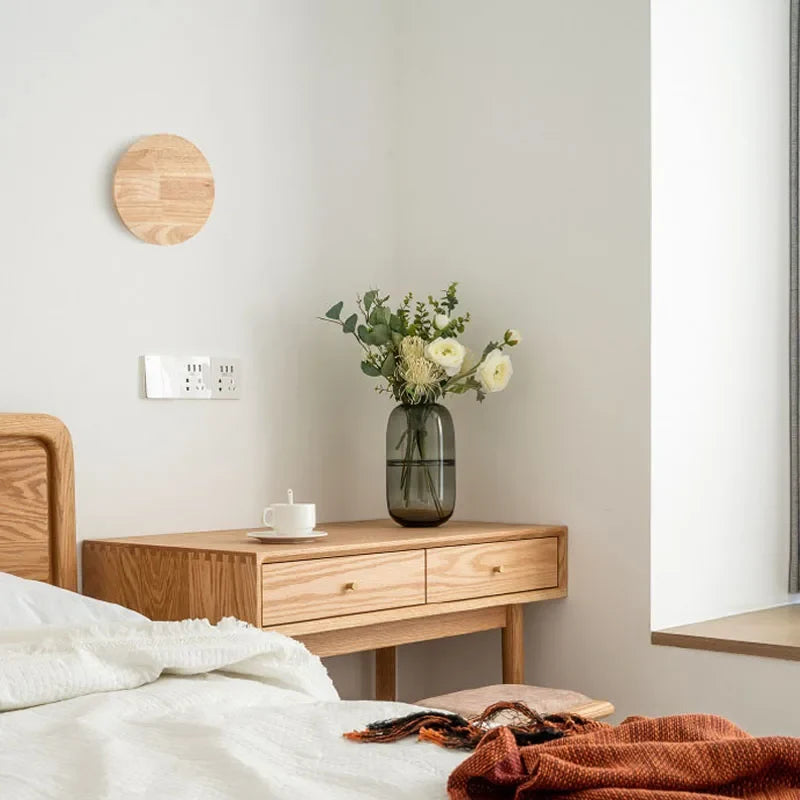Elegant minimalist Scandinavian wooden wall lamp casting a warm, inviting glow for modern interiors.