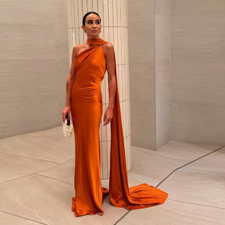 Chic women's elegant full-length cape maxi dress. One-shoulder formal evening gown, a showstopper for any event.
