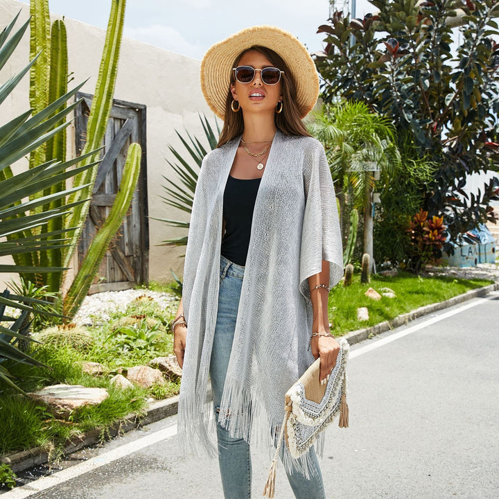 Women's elegant flowy fringe kimono, perfect for stylish summer resort wear.