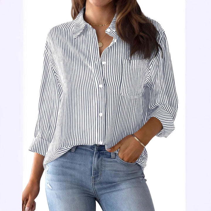 Stylish women's striped shirt, featuring roll-up sleeves and a functional chest pocket.