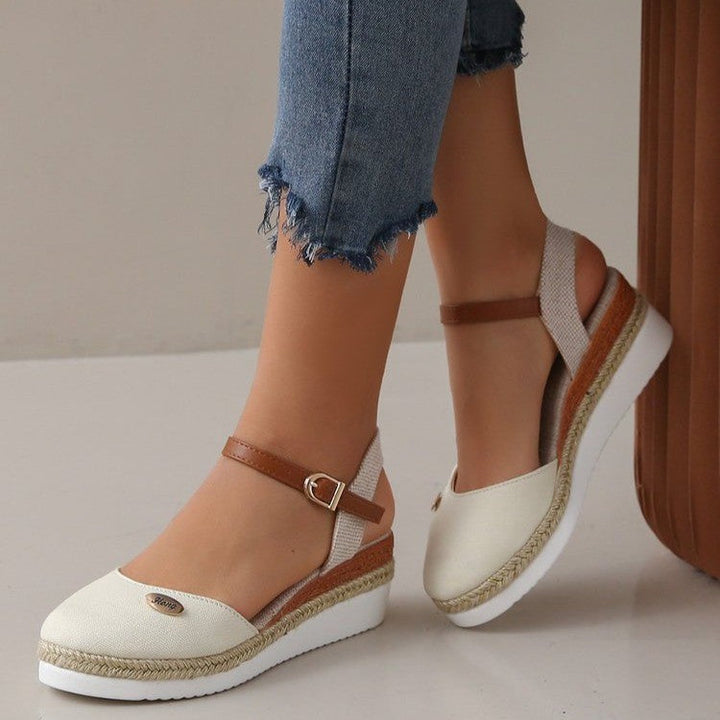 Elegant open-toe wedge sandals for women, featuring a chic woven strap and comfortable fit.