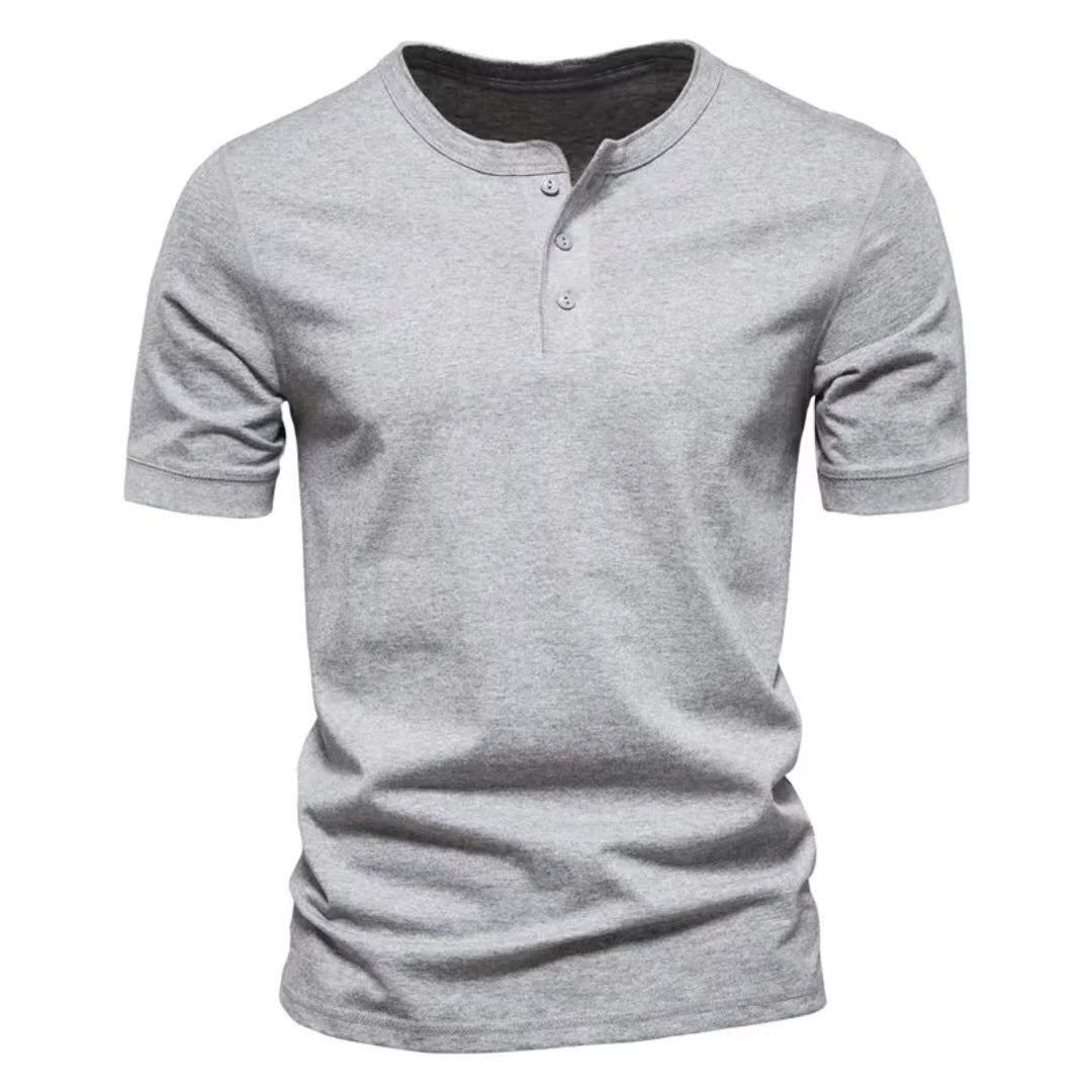 Detail shot of the button placket on a men's short sleeve Henley shirt, casual style.