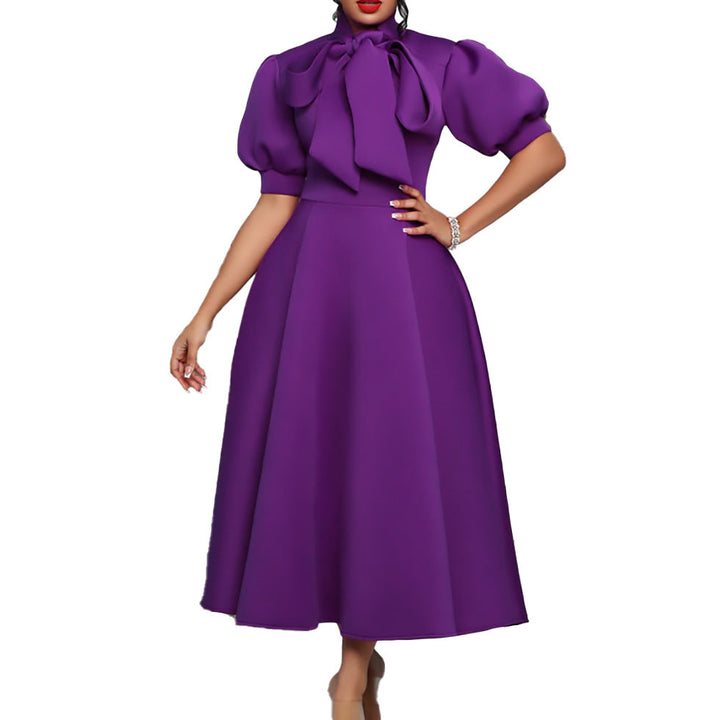 Sophisticated long elegant maxi dress for women, featuring statement puff sleeves and a delicate bow neckline.