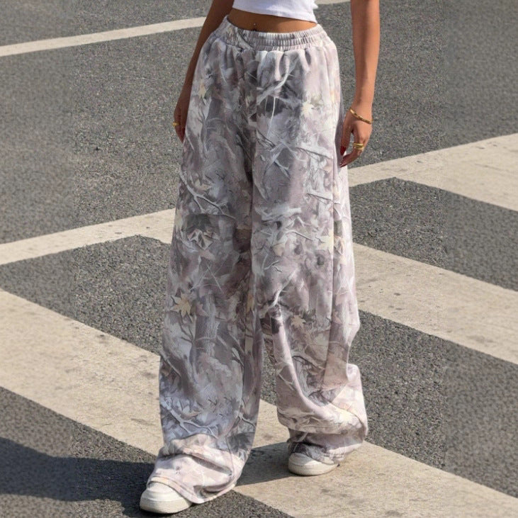 Model wearing comfortable women's printed wide leg pants with elastic waist, ideal for casual summer style.