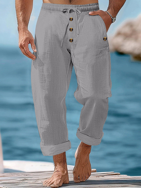 Detail shot of men's casual pants showing adjustable drawstring waist, relaxed fit, summer style.