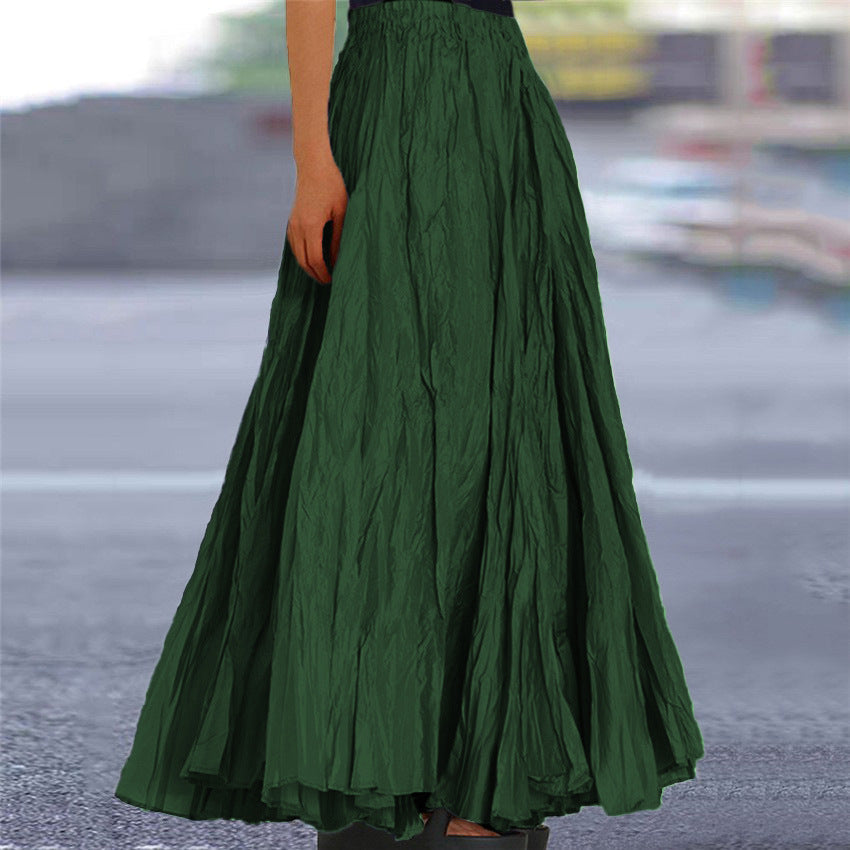 Women's pleated flowing maxi skirt, A-line, elastic waist, shown in a natural setting.