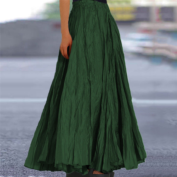 Women's pleated flowing maxi skirt, A-line, elastic waist, shown in a natural setting.
