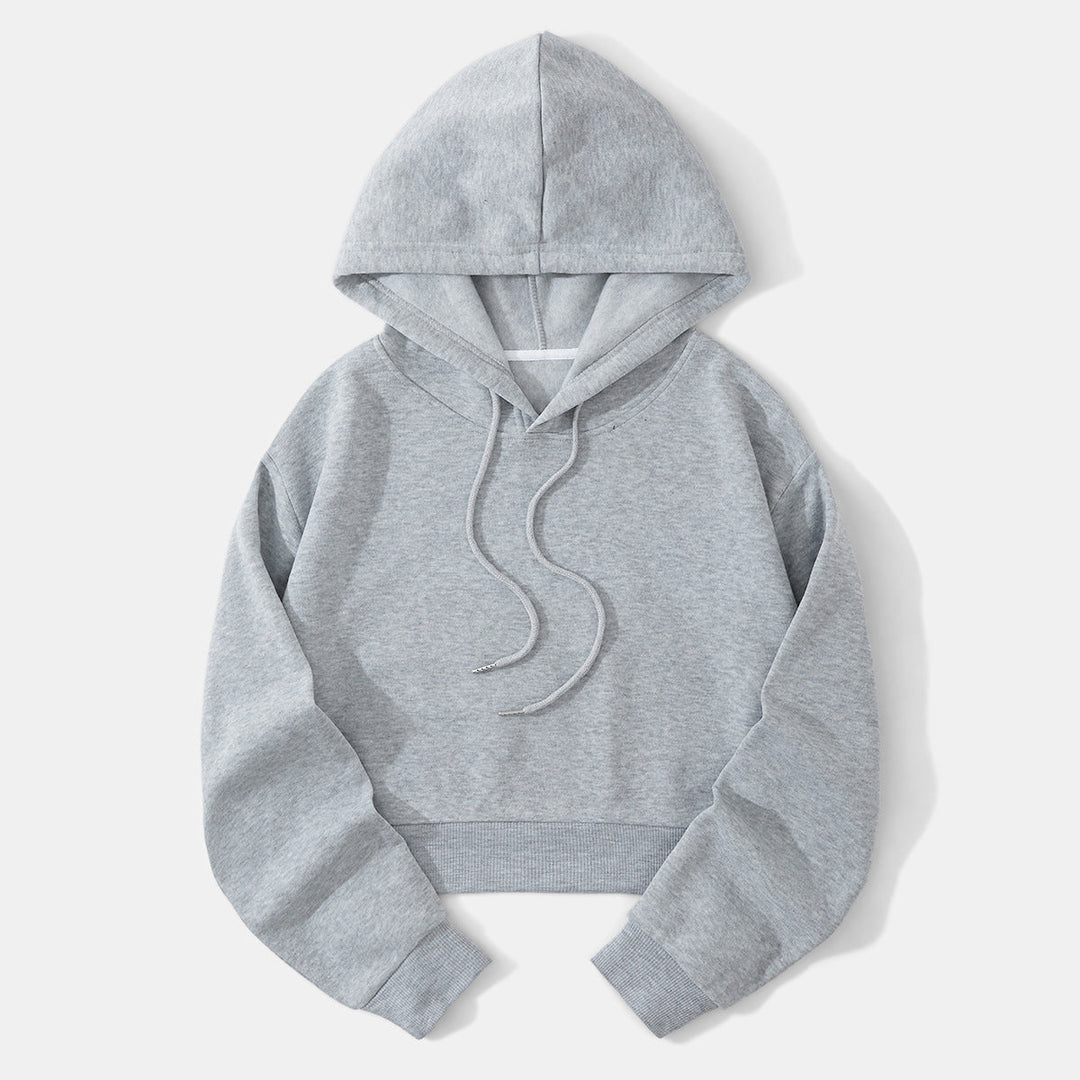 Cropped hem detail of a modern women's hoodie, a fashionable casual top.