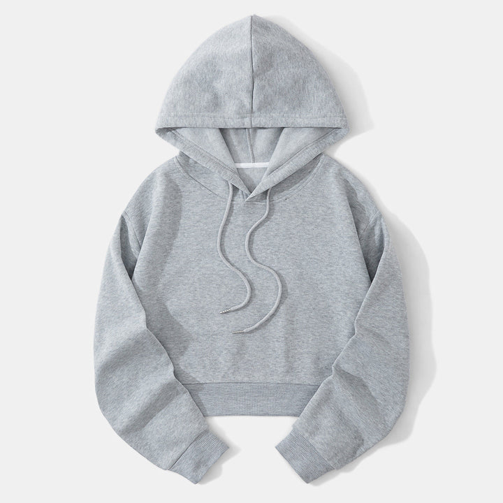 Cropped hem detail of a modern women's hoodie, a fashionable casual top.